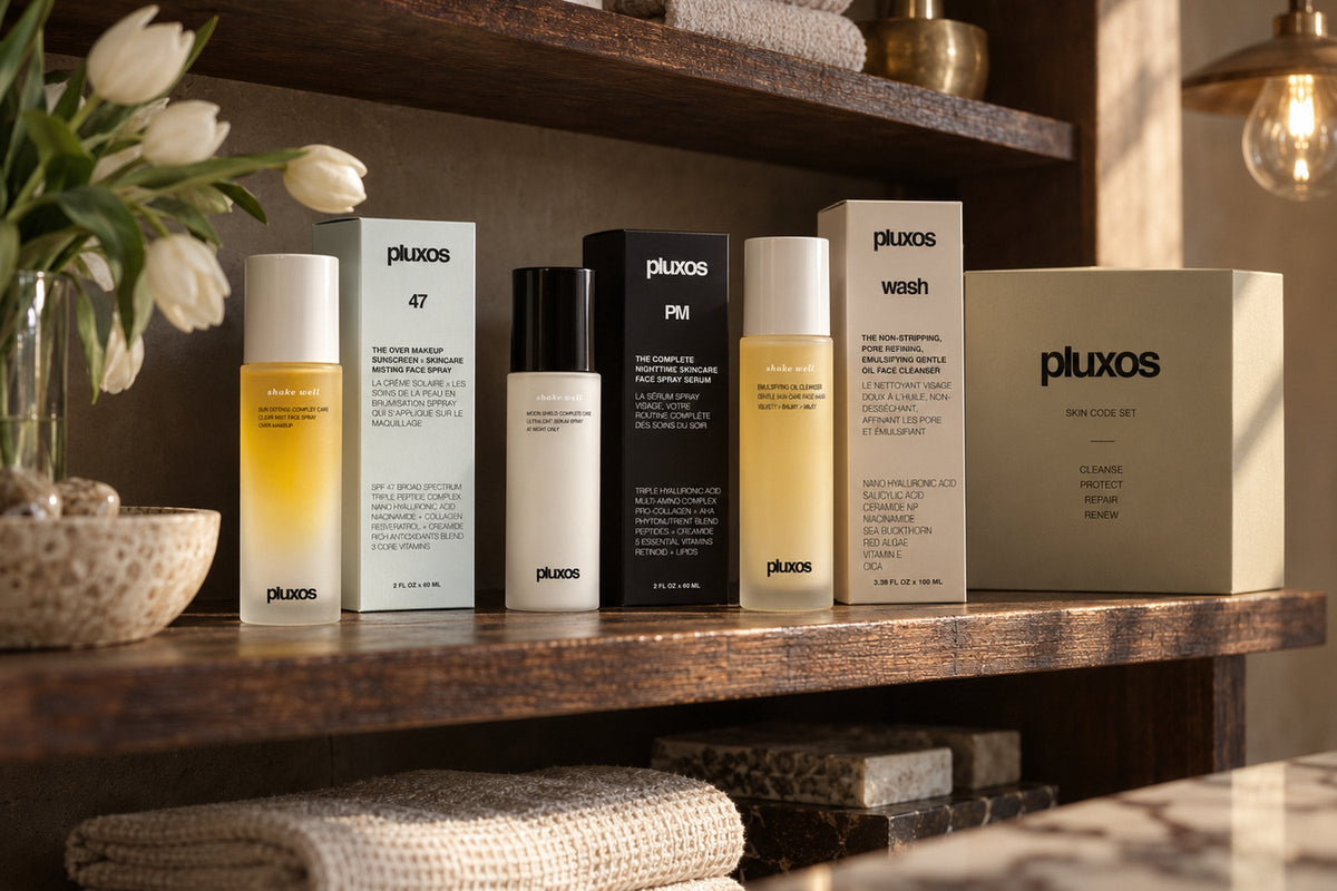 Pluxos Sun Veil 47, Nocturne, Dusk and the Skin Code Set on a walnut shelf in warm light